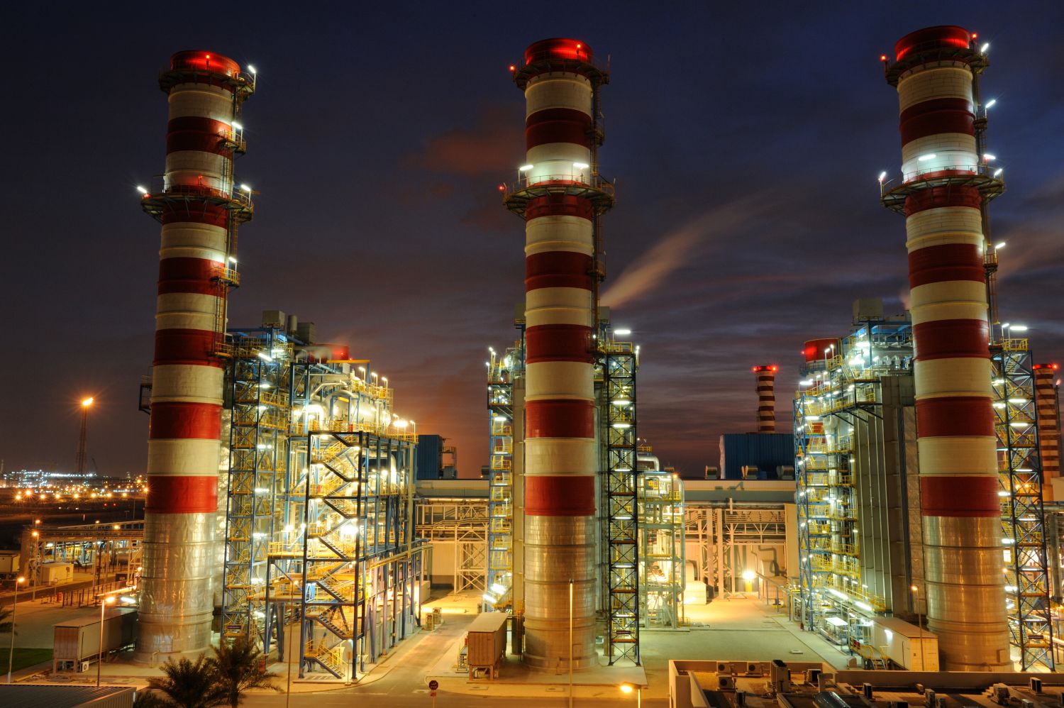 QPOWER power plant illuminated at night in Ras Laffan Industrial City